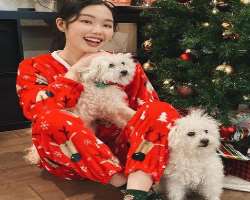 Nina is accompanied by two cute dogs in her home.